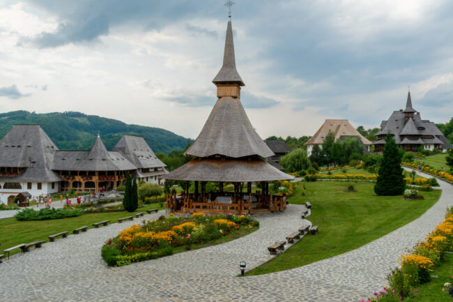 Wooden buildings in the courtyard of Barsana Monastery, Maramures, Romania