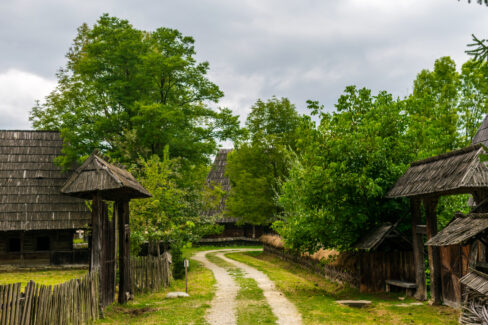 The village street with traditional houses on each part of the way, Maramures Village Museum, Romania